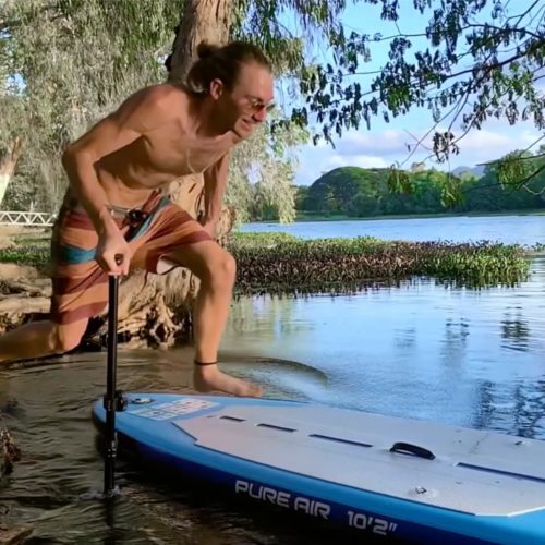 Man jumps on a SUP with a SCUBAJET mounted on it